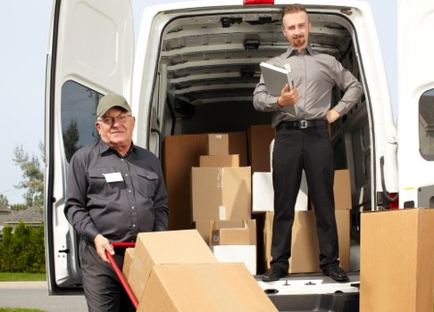 Man and van removal team working in Old Ford with moving boxes